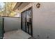 Private patio with security gate and outside light at 9027 W Elm St # 5, Phoenix, AZ 85037