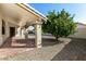 Backyard patio with gravel landscaping and a mature citrus tree at 9715 W Escuda Dr, Peoria, AZ 85382