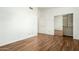 Spacious bedroom featuring wood-look floors and mirrored closet doors at 9715 W Escuda Dr, Peoria, AZ 85382