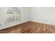 Bright bedroom with wood-look floors and an arched window at 9715 W Escuda Dr, Peoria, AZ 85382