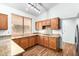 L-shaped kitchen with granite countertops and wood cabinets at 9715 W Escuda Dr, Peoria, AZ 85382