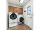 Laundry room with washer, dryer, and upper cabinets at 9715 W Escuda Dr, Peoria, AZ 85382