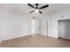 Bedroom with ceiling fan, mirrored closet doors and built-in drawers at 10127 W Forrester Dr, Sun City, AZ 85351