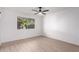 Well-lit bedroom featuring a ceiling fan and large window at 10127 W Forrester Dr, Sun City, AZ 85351