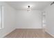 Simple dining room with light flooring and modern light fixture at 10127 W Forrester Dr, Sun City, AZ 85351