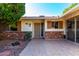 Front entry with security door and brick accents at 10127 W Forrester Dr, Sun City, AZ 85351