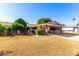 Ranch-style home with carport, mature landscaping, and spacious yard at 10127 W Forrester Dr, Sun City, AZ 85351