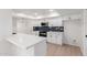 Bright kitchen featuring white cabinets, quartz countertops, and blue tile backsplash at 10127 W Forrester Dr, Sun City, AZ 85351