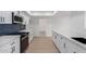 Renovated kitchen boasts white cabinets, quartz countertops, and stainless steel appliances at 10127 W Forrester Dr, Sun City, AZ 85351