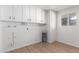 Laundry room with built-in cabinets and vinyl flooring at 10127 W Forrester Dr, Sun City, AZ 85351