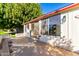 Large covered patio with sliding glass doors and surrounding trees at 10127 W Forrester Dr, Sun City, AZ 85351
