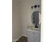 Updated bathroom with gray vanity, oval mirror, and modern lighting at 10220 N 36Th N Ave, Phoenix, AZ 85051