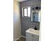 Stylish bathroom with patterned wall tile, gray vanity, and modern fixtures at 10220 N 36Th N Ave, Phoenix, AZ 85051