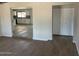 Open living room with wood-look tile floors and a view into the kitchen at 10220 N 36Th N Ave, Phoenix, AZ 85051