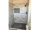 Modern shower with marble-look tile and pebble floor at 10220 N 36Th N Ave, Phoenix, AZ 85051