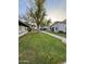 Landscaped lawn area with mature trees and walkway at 1051 N 84Th Pl, Scottsdale, AZ 85257