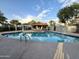 Community swimming pool with lounge chairs and shaded area at 1051 N 84Th Pl, Scottsdale, AZ 85257