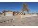 Ranch-style house with a white picket fence and a large tree in the front yard at 11214 S 203Rd Ln, Buckeye, AZ 85326