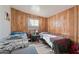 Small bedroom with two twin beds and wood paneling at 11624 N 25Th Ave, Phoenix, AZ 85029