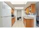 Galley kitchen with wood cabinets and stainless steel appliances at 11624 N 25Th Ave, Phoenix, AZ 85029