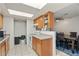 Efficient kitchen with wood cabinets and a dining area at 11624 N 25Th Ave, Phoenix, AZ 85029