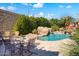 Inviting pool area with seating and a tranquil waterfall at 12294 N 88Th Pl, Scottsdale, AZ 85260