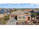 Single-story home with a two-car garage and landscaped front yard at 13036 W Fetlock Trl, Peoria, AZ 85383