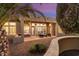 Backyard patio with seating area and desert landscaping at 13036 W Fetlock Trl, Peoria, AZ 85383