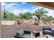 Relaxing backyard patio with seating and desert landscaping at 13036 W Fetlock Trl, Peoria, AZ 85383