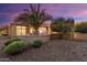 Landscaped backyard with gravel, curved wall, and palm trees at 13036 W Fetlock Trl, Peoria, AZ 85383