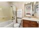 Bathroom with tub shower combo, vanity, and linen closet at 13036 W Fetlock Trl, Peoria, AZ 85383