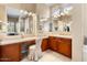 Spacious bathroom with dual sinks, vanity, and a view into another room at 13036 W Fetlock Trl, Peoria, AZ 85383