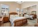 Bright bedroom with wood bed frame and mirrored closet doors at 13036 W Fetlock Trl, Peoria, AZ 85383