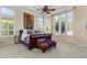 Main bedroom with a king-size bed and large windows at 13036 W Fetlock Trl, Peoria, AZ 85383