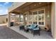 Covered patio with seating area, ceiling fans, and built-in grill at 13036 W Fetlock Trl, Peoria, AZ 85383