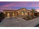 Two-car garage and desert landscaping; inviting curb appeal at 13036 W Fetlock Trl, Peoria, AZ 85383
