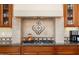 Kitchen detail showing cooktop and decorative tile backsplash at 13036 W Fetlock Trl, Peoria, AZ 85383