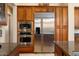 Stainless steel appliances and wood cabinetry in kitchen at 13036 W Fetlock Trl, Peoria, AZ 85383