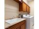 Laundry room with washer, dryer, and ample cabinetry at 13036 W Fetlock Trl, Peoria, AZ 85383