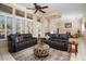 Spacious living room with leather sofas and tile floors at 13036 W Fetlock Trl, Peoria, AZ 85383