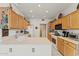 Bright kitchen featuring light wood cabinets and a double sink at 15175 W Carbine Way, Sun City West, AZ 85375