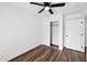 Well-lit bedroom with double door closet and wood-look flooring at 17452 W Ventura St, Surprise, AZ 85388