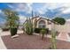Landscaped yard with cacti and desert plants accents this home's exterior at 18807 N 2Nd Ave, Phoenix, AZ 85027