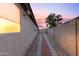 Side yard with a brick pathway and gravel landscaping at 18807 N 2Nd Ave, Phoenix, AZ 85027