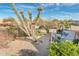 Expansive desert landscape backyard view with a built-in grill and outdoor seating area at 18932 N Aztec Point Dr, Surprise, AZ 85387