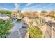 Entertain outdoors in this backyard with mature trees and desert landscaping at 18932 N Aztec Point Dr, Surprise, AZ 85387