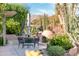 Enjoy an intimate outdoor gathering space in this backyard with lush landscaping at 18932 N Aztec Point Dr, Surprise, AZ 85387