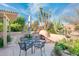 Relax in this backyard with desert landscaping and cozy outdoor fireplace at 18932 N Aztec Point Dr, Surprise, AZ 85387
