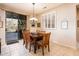 Bright dining room with natural light, wood table, and views of the desert landscape through the sliding glass door at 18932 N Aztec Point Dr, Surprise, AZ 85387