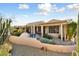 Landscaped backyard with a covered patio and desert plants at 18932 N Aztec Point Dr, Surprise, AZ 85387